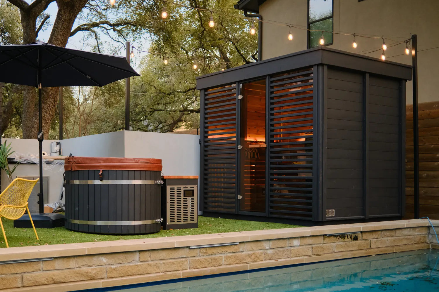 Modern outdoor sauna beside a residential pool