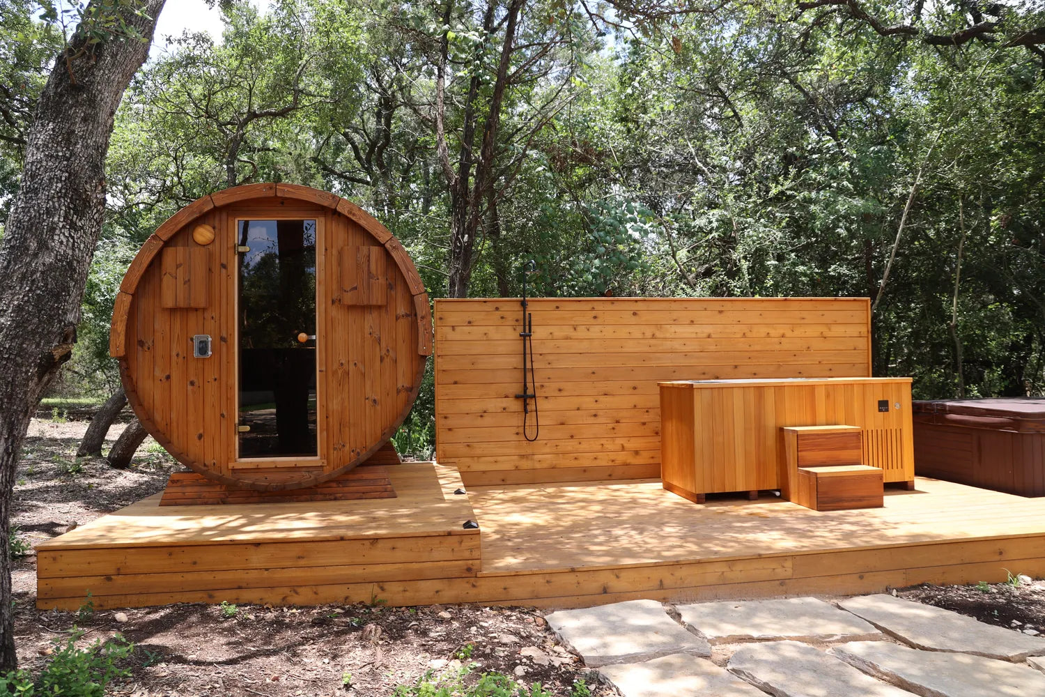 Outdoor sauna integrated into a woodland deck